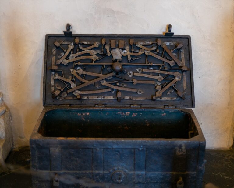 Antique chest with a complex lock in the castle on the floor.