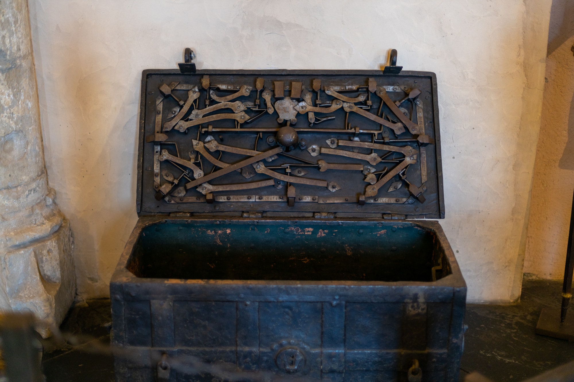 Antique chest with a complex lock in the castle on the floor.